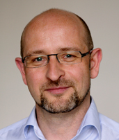 Porträt eines freundlichen Mannes mit Brille.